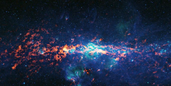 The Sagittarius B2 molecule cloud appears in orange in the center of the Milky Way, to the left of the image.  (European Southern Observatory / Apex & MSX / IPAC / NASA)