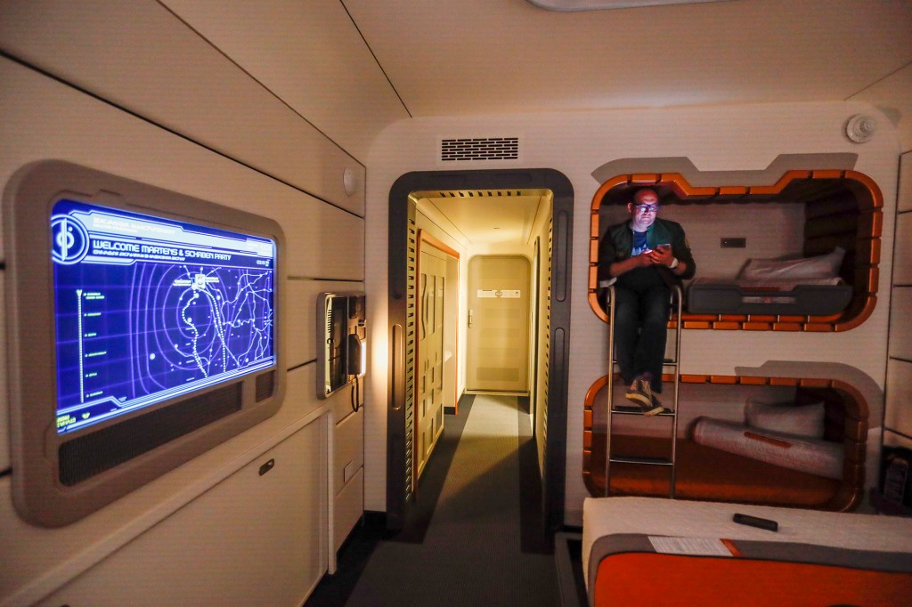 ORLANDO, FL - MARCH 1: Todd Martens, a columnist for the Los Angeles Times, sat in one of the bunk beds inside a room on the Halcyon ship.  The first passengers arrive on the two-day Walt Disney World Star Wars Galactic Starcruiser, a live-action role-playing game that doubles as an upscale hotel in Orlando, Florida.  The event is called the Halcyons' 275th Anniversary Journey across the galaxy.  At the Walt Disney World Star Wars Galactic Starcruiser in Orlando, Florida on Tuesday, March 1, 2022. First Lieutenant Harman Croy and his garrison of Stormtroopers patrol the ship.  Guests arrive at Batuu, the planet's trek destination.  Players use a dashboard for immersive game play as they engage in activities such as light sword training.  (Allen J. Schaben/Los Angeles Times via Getty Images)
