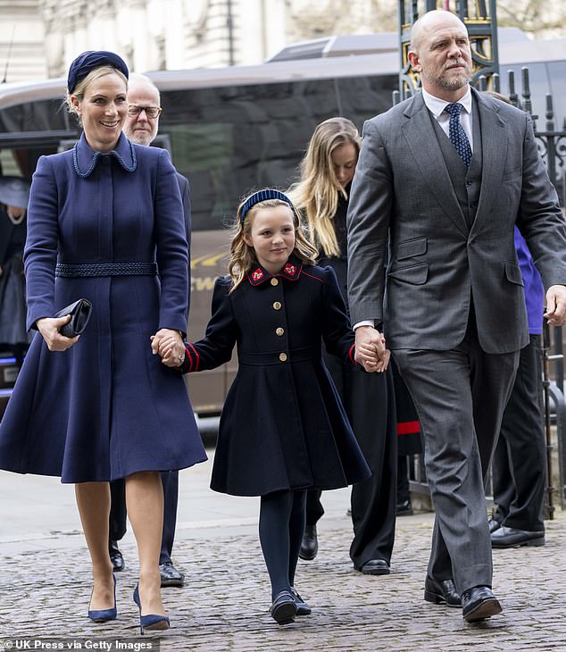 Zara and Mike Tindall walk with their eight-year-old daughter Mia to Westminster Abbey for the Prince Philip Memorial, wearing the £79 Mia Navy Military Coat