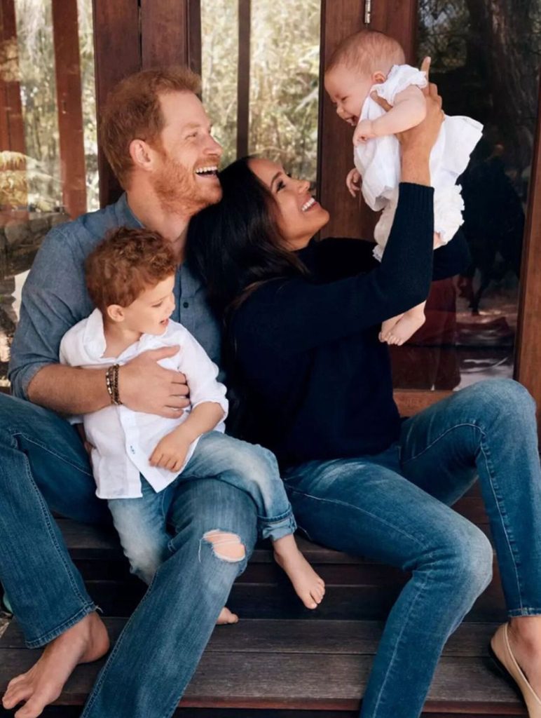 The Christmas photo is only the second photo the couple has released of their daughter after it appeared on the family's Christmas card last year.  Older brother Archie is seen on Harry's lap. 