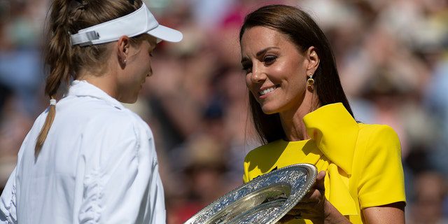 The Duchess of Cambridge serves a platter of Venue Rosewater to Elena Rybakina, who won her match against Ons Jabeur during the women's singles final at Wimbledon on July 9, 2022 in London. 
