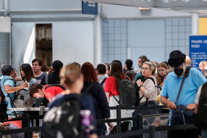 Passengers wait in line at O'Hare International Airport on June 30, 2022 in Chicago.