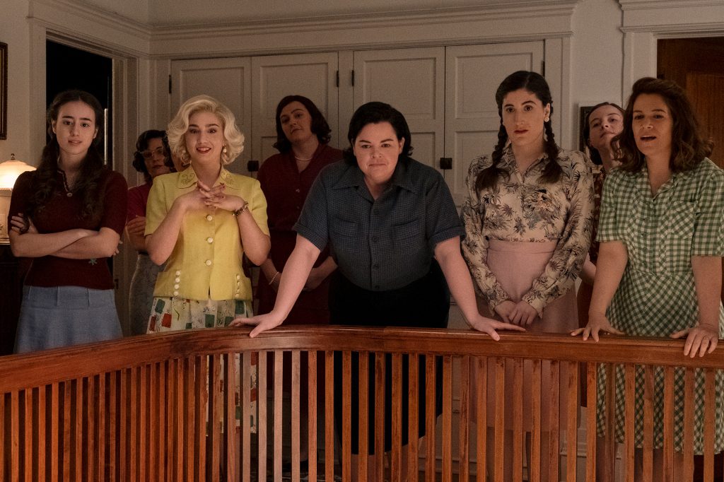 Team members Esti (Priscilla Delgado), Maybelle (Molly Ephraim), Jo (Melanie Field), Shirley (Kate Berlant), and Carson (Abbi Jacobson) stand beside the ladder balcony. 