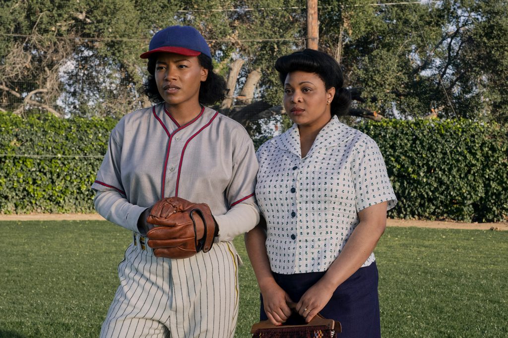 Pitcher Max (Chanté Adams) and her friend Clance (Gbemisola Ikumelo), right, jump in a field. 