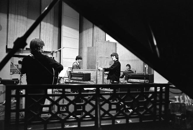 John Lennon, Paul McCartney, George Harrison and Ringo Starr work "pistol" At Abbey Road Studios.  Producer Giles Martin says: 