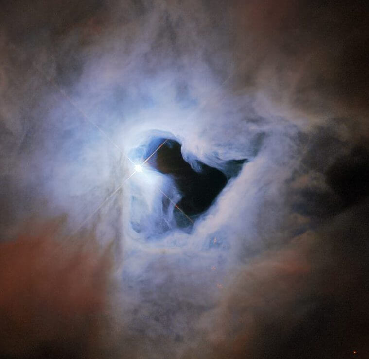 A keyhole-shaped dark cavity, the "NGC 1999" reflection nebula photographed by Hubble |  Sorae Portal site to space