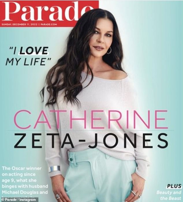 Still gorgeous: Catherine Zeta-Jones unveiled her new cover of Parade in a chic off-the-shoulder jacket and turquoise pants
